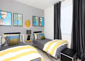 Thumbnail 6 of 45 - a bedroom with two twin beds with yellow and gray bedding at The Vines at Riverpark, LLC, Oxnard California