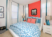 Thumbnail 7 of 45 - a bedroom with a bed and a red wall and white curtains at The Vines at Riverpark, LLC, Oxnard, CA 93036
