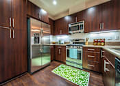 Thumbnail 8 of 45 - a kitchen with stainless steel appliances and wooden cabinets at The Vines at Riverpark, LLC, Oxnard California