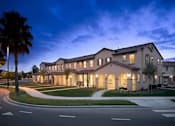 Thumbnail 2 of 45 - a large building with a palm tree in front of it at The Vines at Riverpark, LLC, Oxnard, CA