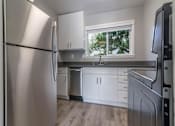 Thumbnail 10 of 14 - a kitchen with white cabinets and a window at The Pier at Sausalito, Sausalito California