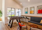 Thumbnail 8 of 25 - a game room with a foosball table and chairs at Parc Medallion LLC, Union City