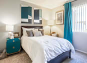 Thumbnail 14 of 25 - a bedroom with a white bed and blue curtains at Parc Medallion LLC, Union City, 94587