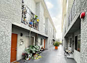Thumbnail 17 of 19 - a courtyard between two buildings with potted plants at The Marq Apartments LLC, California, 90042