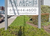 Thumbnail 32 of 39 - a sign for the arches apartments on the side of a street at The Arches Apartments, El Cajon, CA