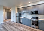 Thumbnail 13 of 28 - Modern kitchen with stainless steel appliances at 888 Fourth Street Apartments, LLC, Santa Rosa, CA, 95404