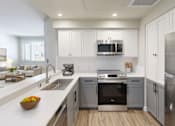 Thumbnail 7 of 28 - Modern kitchen with white cabinetry at 888 Fourth Street Apartments, LLC, Santa Rosa