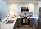 Thumbnail 6 of 28 - Kitchen with stovetop oven at 888 Fourth Street Apartments, LLC, Santa Rosa, CA, 95404