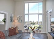 Thumbnail 8 of 28 - Living room with a grey couch at 888 Fourth Street Apartments, LLC, Santa Rosa, California