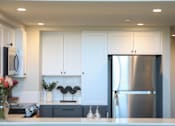 Thumbnail 15 of 28 - Modern kitchen with stainless steel refrigerator at 888 Fourth Street Apartments, LLC, California, 95404