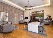 Thumbnail 11 of 60 - A modern living room with a white marble coffee table and a chandelier hanging from the ceiling. at Cirrus Redwood City Apartments, Redwood City, 94061