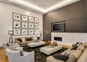 Thumbnail 13 of 60 - A modern living room with a fireplace and a TV. at Cirrus Redwood City Apartments, Redwood City, CA, 94061