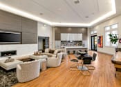 Thumbnail 10 of 60 - A modern living room with a fireplace and a dining table. at Cirrus Redwood City Apartments, Redwood City, 94061