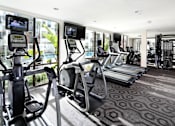 Thumbnail 3 of 60 - A gym with treadmills and elliptical machines. at Cirrus Redwood City Apartments, Redwood City, CA, 94061