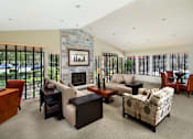 Thumbnail 11 of 21 - A living room with a fireplace and a painting on the wall. at The Maddox Sunnyvale Apartments, Sunnyvale, CA, 94087