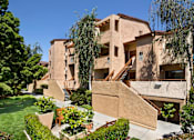 Thumbnail 10 of 21 - A beige building with a staircase in the middle of it. at The Maddox Sunnyvale Apartments, California, 94087