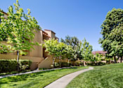 Thumbnail 16 of 21 - A building with a green lawn in front of it. at The Maddox Sunnyvale Apartments, Sunnyvale