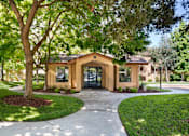 Thumbnail 14 of 21 - A small building with a brown roof and tan walls is surrounded by trees and grass. at The Maddox Sunnyvale Apartments, Sunnyvale, CA, 94087