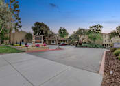 Thumbnail 41 of 90 - a street with a driveway and houses in the background at Summerwood Apartments, California