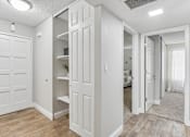 Thumbnail 42 of 90 - a renovated living room with white doors and a closet at Summerwood Apartments, California, 95050