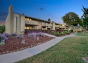 Thumbnail 36 of 90 - a building with a sidewalk and a garden in front of it at Summerwood Apartments, California