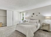 Thumbnail 28 of 90 - a master bedroom with a bed and a closet at Summerwood Apartments, Santa Clara, 95050