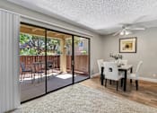 Thumbnail 3 of 90 - a dining room with sliding glass doors to a patio at Summerwood Apartments, Santa Clara, CA 95050