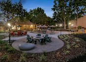 Thumbnail 24 of 90 - a patio with tables and chairs at Summerwood Apartments, Santa Clara, CA 95050