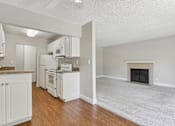 Thumbnail 30 of 90 - a view of a kitchen and a living room with a fireplace at Summerwood Apartments, California, 95050