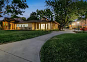 Thumbnail 20 of 90 - the house is lit up at night with the sidewalk in front of it at Summerwood Apartments, Santa Clara, California