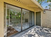 Thumbnail 14 of 90 - a patio with a glass door and a balcony at Summerwood Apartments, Santa Clara, 95050