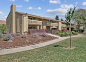 Thumbnail 8 of 90 - an exterior view of a building with a sidewalk and grass at Summerwood Apartments, California