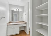 Thumbnail 90 of 90 - a bathroom with a sink and a mirror and a closet at Summerwood Apartments, Santa Clara, CA