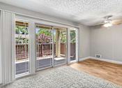 Thumbnail 73 of 90 - an empty living room with sliding glass doors to a patio at Summerwood Apartments, Santa Clara, 95050