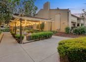 Thumbnail 12 of 90 - a patio with benches and a pavilion with lights at Summerwood Apartments, Santa Clara