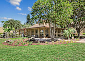 Thumbnail 50 of 90 - a view of a house with trees and grass at Summerwood Apartments, Santa Clara, CA