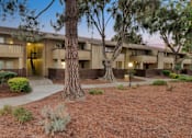 Thumbnail 15 of 90 - an apartment building with a courtyard and trees in front of it at Summerwood Apartments, California