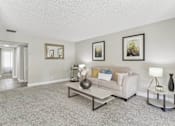 Thumbnail 9 of 90 - a living room with a couch and a coffee table at Summerwood Apartments, California, 95050
