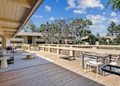 Thumbnail 62 of 90 - a patio with tables and chairs on a balcony at Summerwood Apartments, Santa Clara, CA 95050