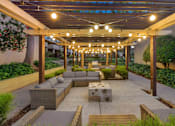 Thumbnail 27 of 90 - a patio with a couch and a table under a canopy at Summerwood Apartments, Santa Clara, California