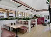 Thumbnail 82 of 90 - a lobby with red chairs and potted plants at Summerwood Apartments, Santa Clara, CA 95050
