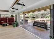Thumbnail 79 of 90 - a living room with sliding glass doors to a patio at Summerwood Apartments, Santa Clara, California