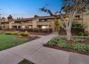 Thumbnail 21 of 90 - a building with a sidewalk and trees in front of it at Summerwood Apartments, Santa Clara, 95050