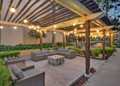 Thumbnail 26 of 90 - a patio with couches and a canopy with lights at Summerwood Apartments, Santa Clara