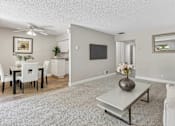 Thumbnail 4 of 90 - a living room with a couch and a table at Summerwood Apartments, Santa Clara, CA