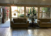 Thumbnail 12 of 23 - Two Couches Are Placed In a Room at Atrium Garden Apartment Homes, LLC, San Jose, California