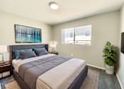 Thumbnail 5 of 18 - A bedroom with a large bed and a painting on the wall.