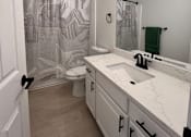 Thumbnail 15 of 32 - a bathroom with a sink and a shower and a toilet at Campbell West Apartments, Campbell