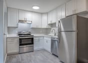 Thumbnail 24 of 40 - a white kitchen with stainless steel appliances and white cabinets  at Danville Park, Danville, CA