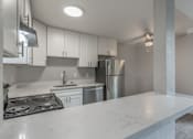 Thumbnail 32 of 40 - a kitchen with white marble counter top and stainless steel appliances at Danville Park, Danville, California